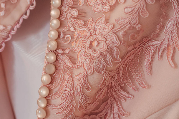 beautiful pink fashion textile with rose flowers on wedding dress at salon  - Photo, Image