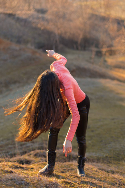 Girl with long hair in spring, Dancing girl in the mountains, heavy metal rock - Foto, immagini