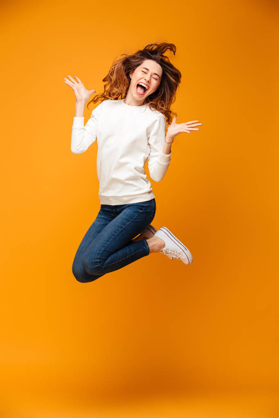 Full length image of Happy screaming brunette woman in sweater - Photo, Image
