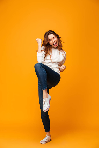 Full length image of Happy brunette woman in sweater screaming - Foto, immagini