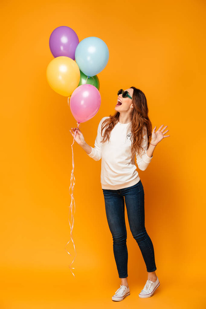 Full length image of Cheerful woman in sweater and sunglasses - Foto, Imagem