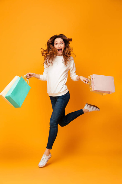 Full length image of Surprised happy woman in sweater running - Zdjęcie, obraz