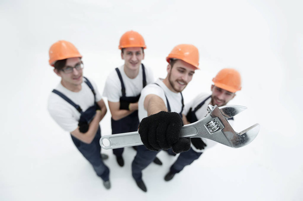 closeup.a team of builders showing a pipe wrench - Φωτογραφία, εικόνα