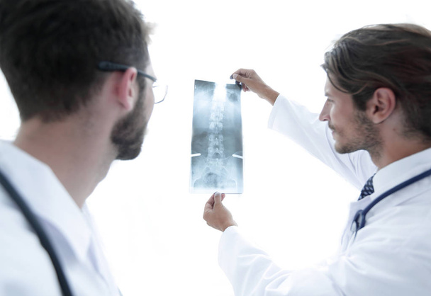 Portrait of happy surgeons holding x-ray report - 写真・画像