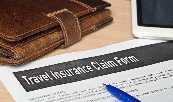 travel insurance claim form on a wooden surface - Photo, Image