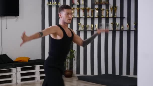 The professional dancer rehearses. He is in the hall for rehearsals. Rehearses the dance contemporary. contemporary. it is constantly improved and unites in itself various dancing techniques - Footage, Video