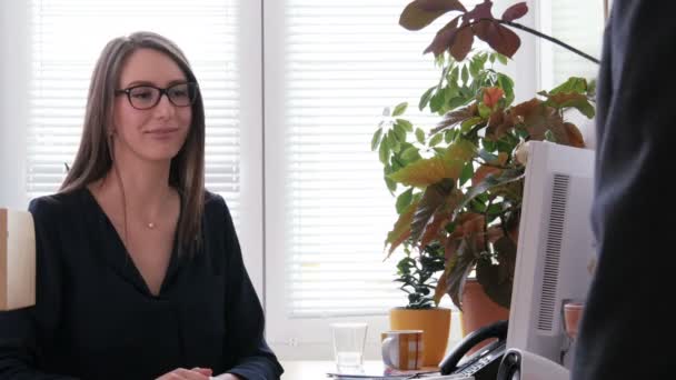 Un reclutador de trabajo femenino termina la entrevista de trabajo estrechando la mano con su solicitante
 - Metraje, vídeo