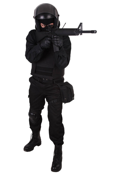 SWAT officer with assault rifle in black uniform - Fotó, kép