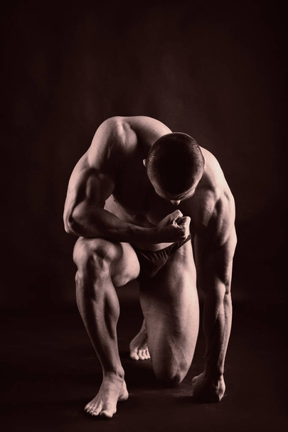 Portrait of a bodybuilder. Toned photo - Φωτογραφία, εικόνα