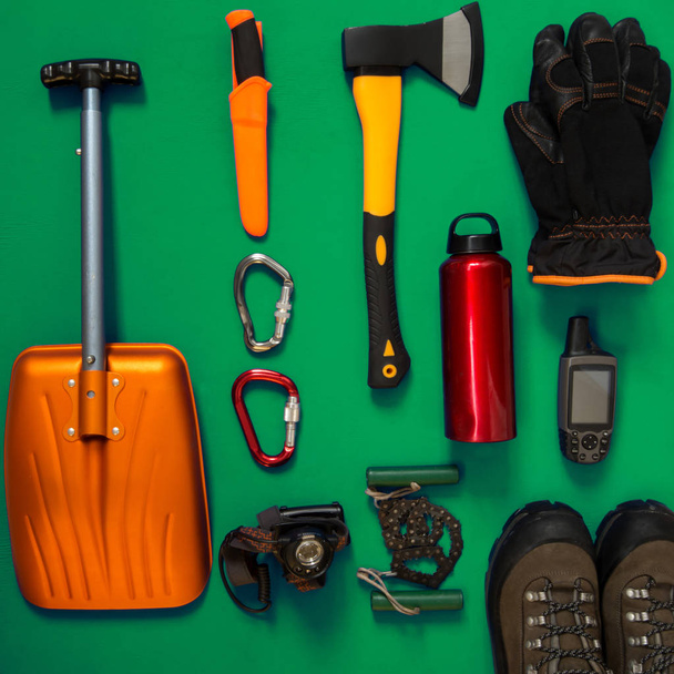 Kit of gear for survival on a green background - Photo, image
