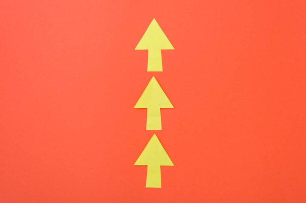 Arrows only forward. Three arrows in one direction. Orange background and bright yellow arrows. - Foto, imagen
