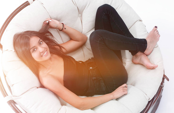 young woman resting in big comfortable armchair - Foto, Imagen