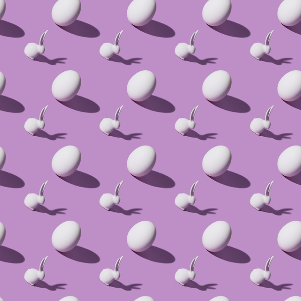 set of chicken eggs and easter rabbits on purple background - Photo, Image