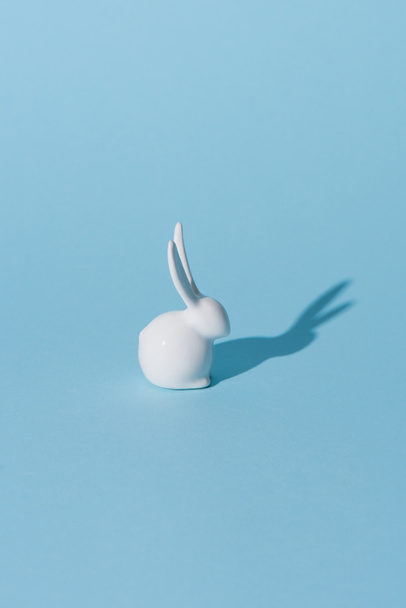 one easter bunny on blue surface - Foto, Imagem