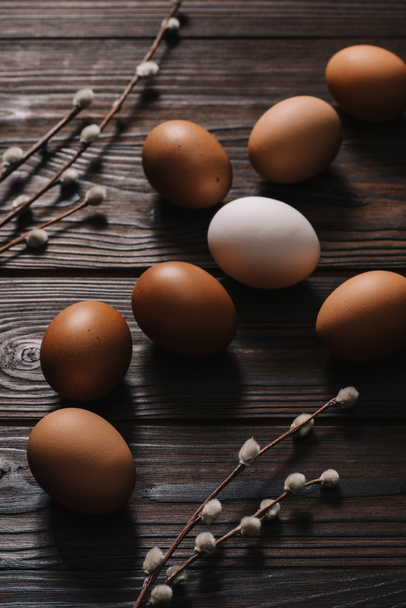 chiken eggs and catkins on wooden table, easter concept - Photo, Image