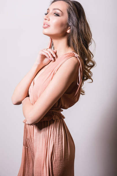 Young beautifull woman in silk dress studio portrait. - Photo, image
