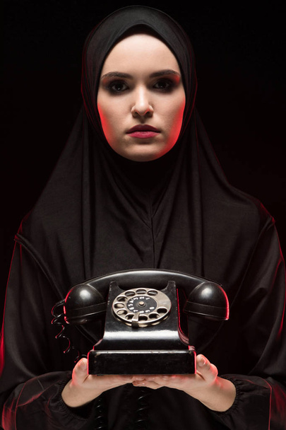 portrait of young Muslim woman holding vintage phone - Photo, Image