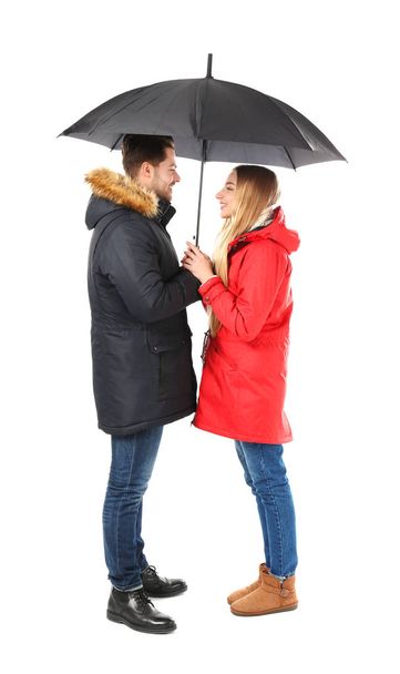 Young romantic couple with umbrella on white background - Foto, afbeelding