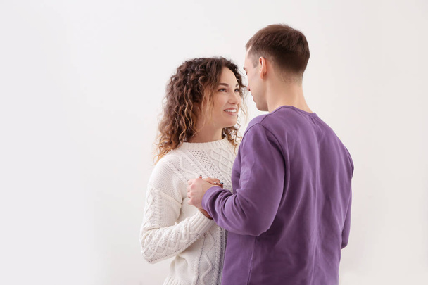 Young loving couple dancing at home on Christmas day - 写真・画像