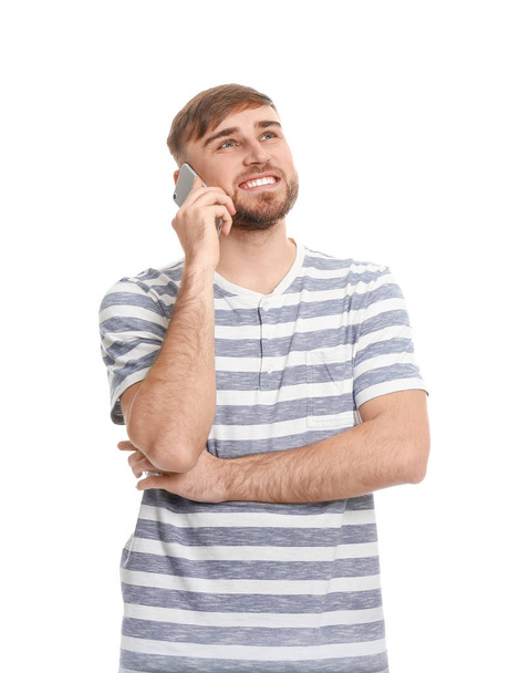 Young man talking on mobile phone against white background - Φωτογραφία, εικόνα