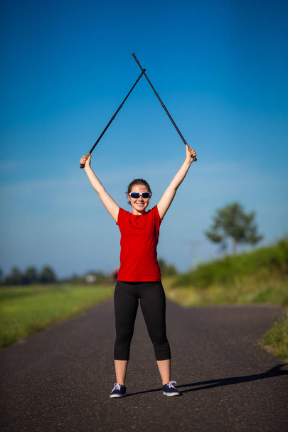 Nordic walking - young woman training - Foto, Bild
