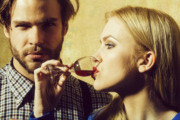 Girlfriend drinking red liqueur in glass and boyfriend - Fotó, kép