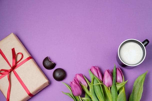 Purple tulips, coffee and sweets on a violet background. Spring  - Φωτογραφία, εικόνα