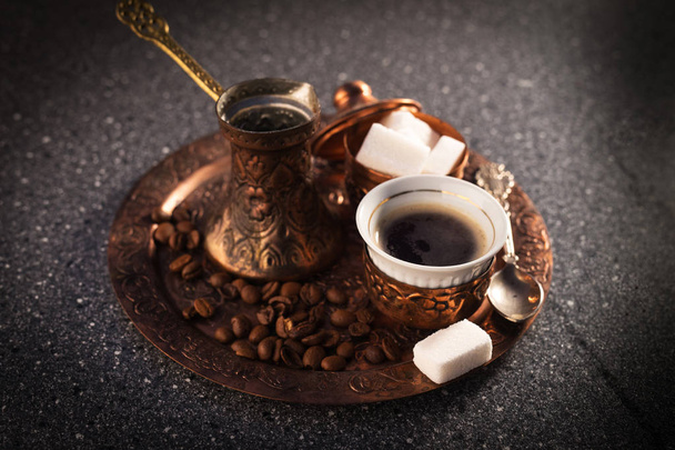 Turkish coffee on metal tray served with loaf-sugar  - Фото, зображення