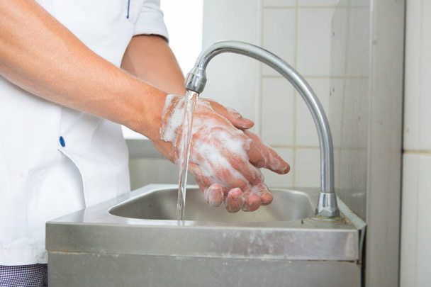 man washing hands in sink close up view - Foto, imagen