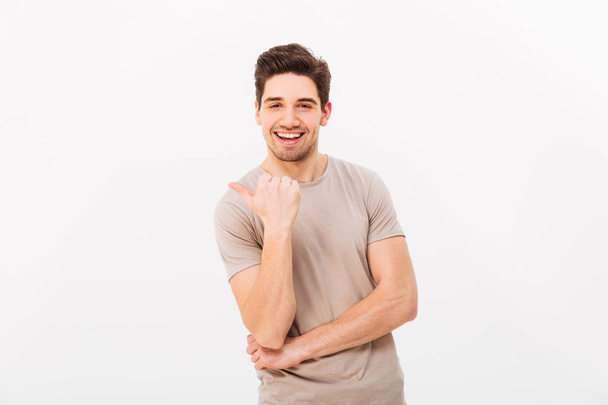 Confident cheerful man 30s with brown hair gesturing finger asid - Fotografie, Obrázek