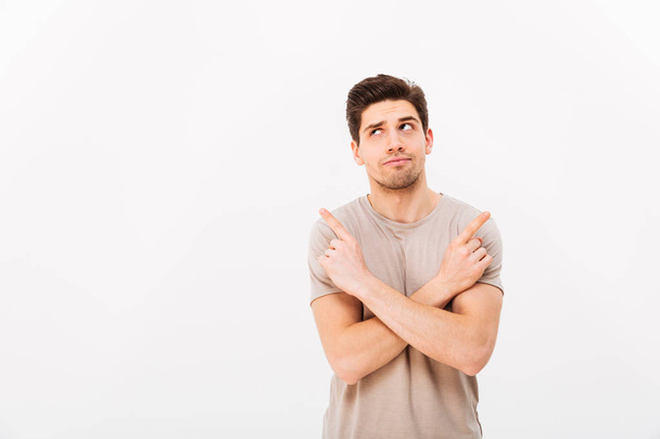 Image of muscular brooding man wearing beige t-shirt gesturing f - Photo, image