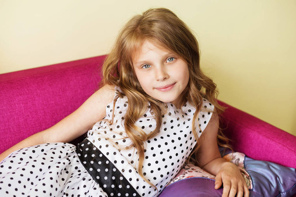 portrait of a lovely little girl in polka dot dress resting on p - Fotografie, Obrázek