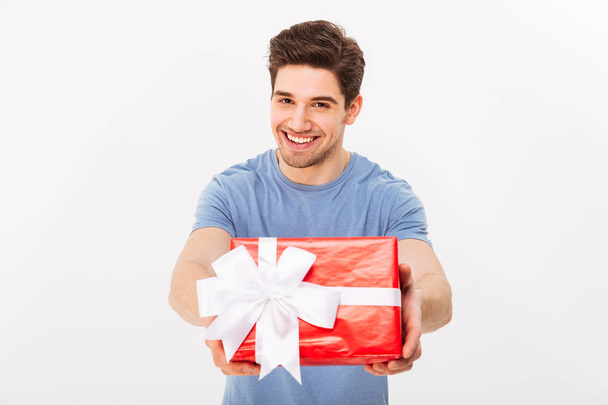 Kind attractive man with beautiful smile giving birthday present - Foto, afbeelding