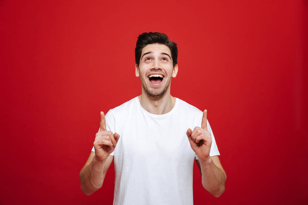 Portrait of a joyful young man in white t-shirt - Zdjęcie, obraz