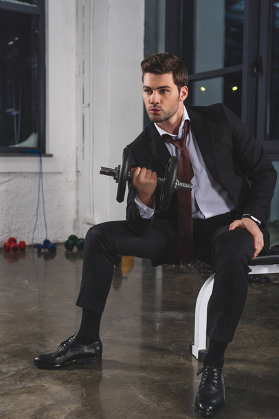 sporty manager in suit training with dumbbell in gym - Fotoğraf, Görsel