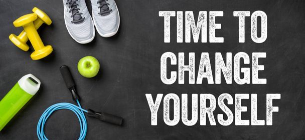 Fitness equipment on a dark background - Time to change yourself - Photo, Image