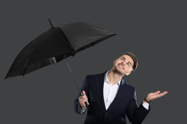 Young man in elegant suit with umbrella - Фото, изображение