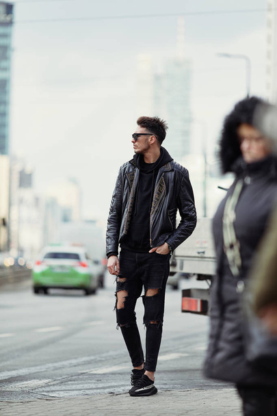 Model looking man stand on the city street with cars background, - 写真・画像