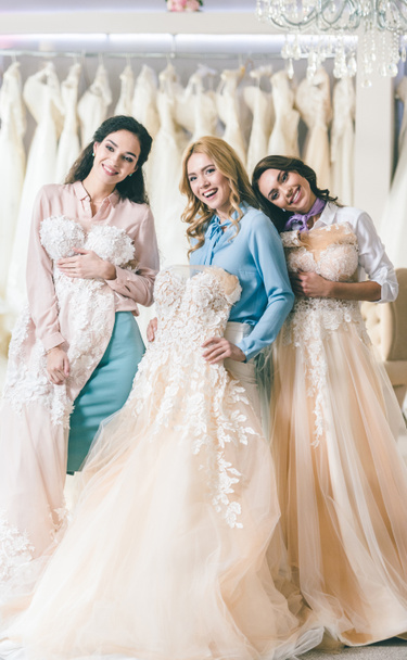 Attractive women with wedding dresses in wedding fashion shop - Photo, Image