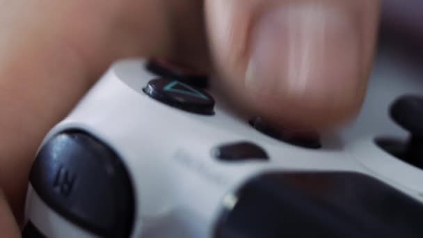 Close up of male hands holding a joystick controller while playing a video games at home - Young man having fun with games - Gaming, entertainment, technology concept. - Záběry, video