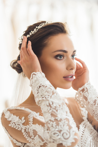 Attractive woman wearing hair accessory in wedding salon - Photo, Image