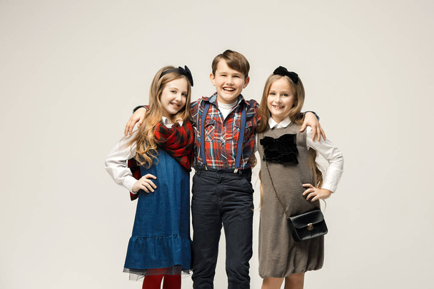 Cute stylish children on white studio background - Fotografie, Obrázek