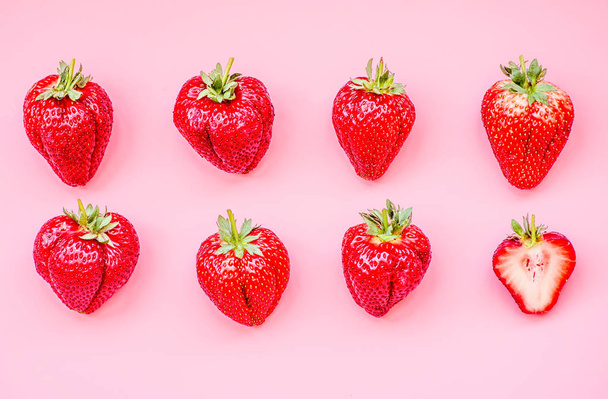 creative layout large strawberries on pink background top view - Фото, изображение