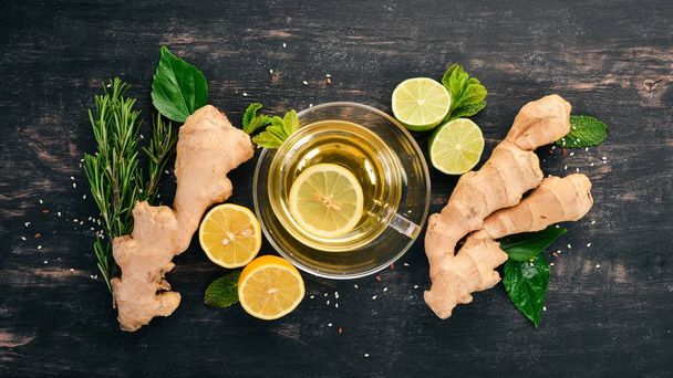 Tea with mint, ginger and lemon. Hot drink On a wooden background. Top view. Copy space. - Foto, imagen