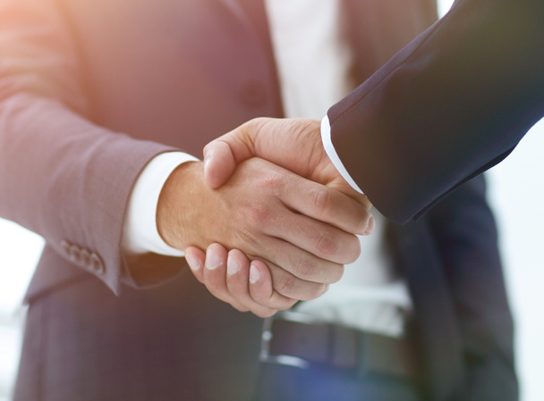close up of two young male business partner shake hand - 写真・画像