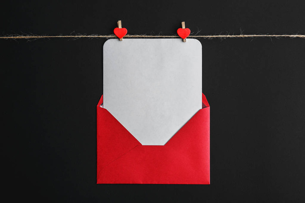 letter with congratulations on a black background, red envelope  - Fotoğraf, Görsel
