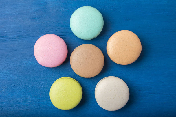 Colorful cookies. Cake macaron or macaroon on a blue background. Copy space 4 - Photo, Image