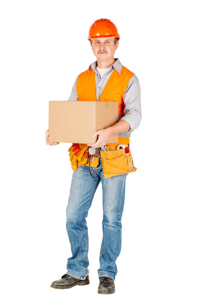 male builder or manual worker in helmet holding and moving  cardboard box on white background. repair, construction, building, people and maintenance concept - Fotoğraf, Görsel