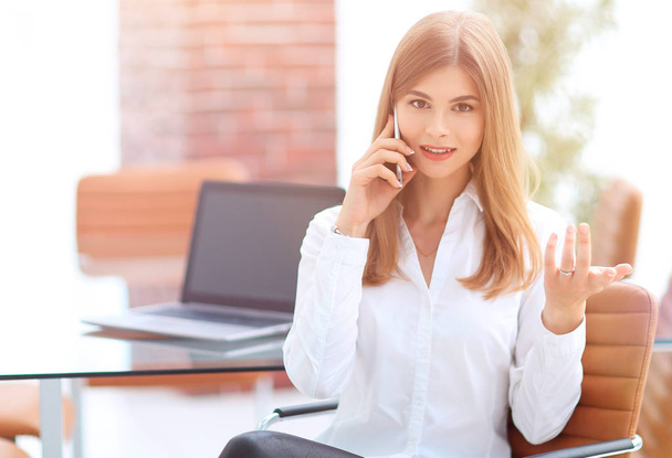 business woman talking on mobile phone sitting in the office - Photo, image