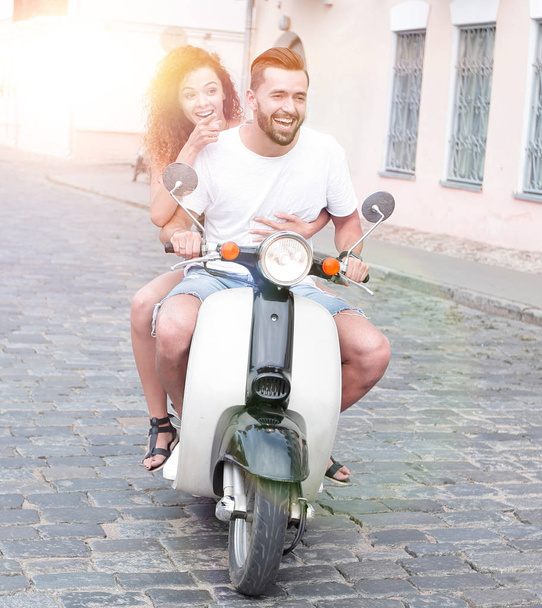 Full length side view of happy couple riding on retro motorbike - Fotografie, Obrázek